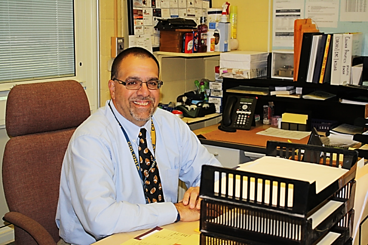 Instead of standing on the sidelines of the football field, CHSs new Athletic Director, Mr. LaSala gets cozy behind his desk in his new office.