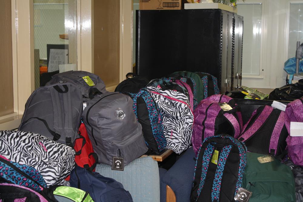 Backpacks+lined+up+and+ready+to+be+sent+away+for+donations.