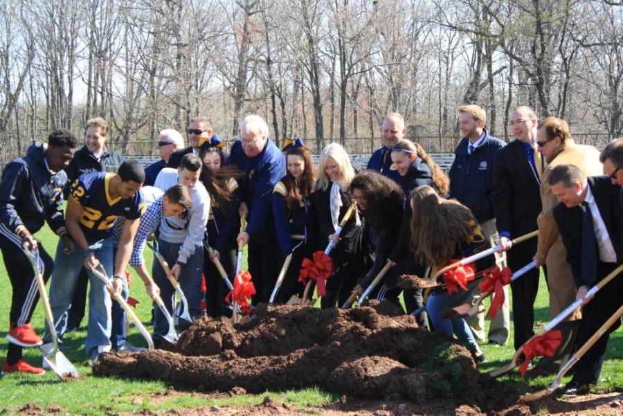 During the ground breaking ceremony, students, coaches, and Board Members join Mayor McCormac in digging for the new stadium.