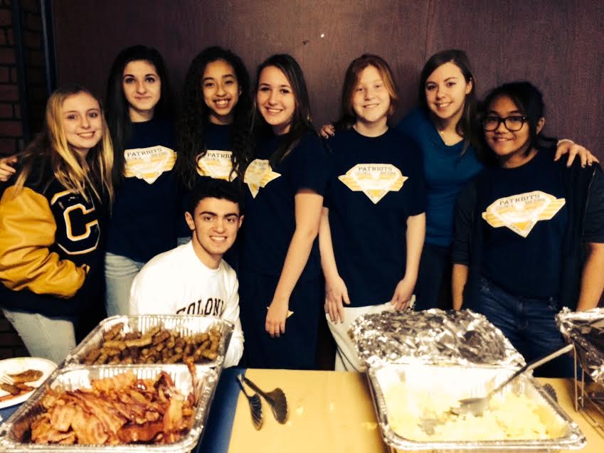 The Colonia High School swim team gets together for a breakfast fundraiser in January 2014.