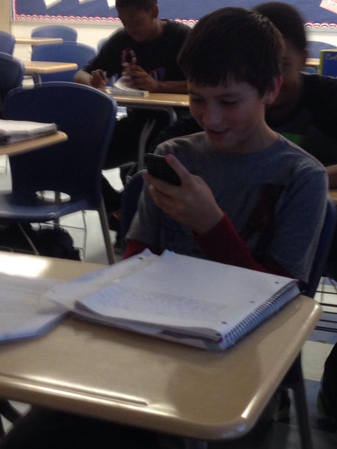 Researching articles on genocide for an essay in English class, Freshman Sean Dressler uses his phone with the teachers permission.
