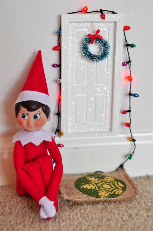 Watching little girls and boys everywhere, this little elf is waiting to report back to Santa.