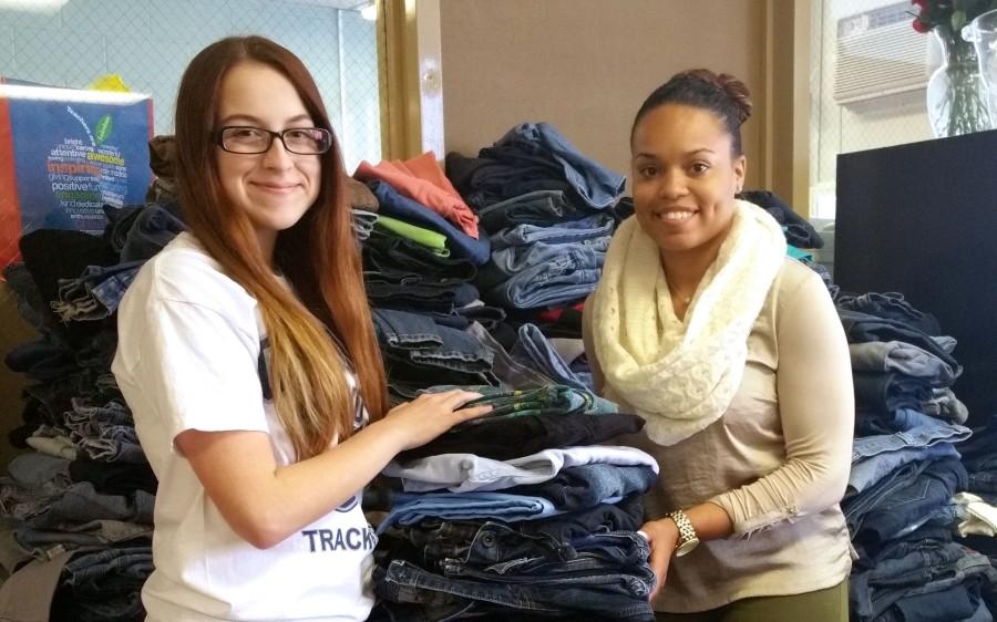 Samantha Girod and Ms. Alisha Davison pile up the jeans collected for the Teens For Jeans campaign 