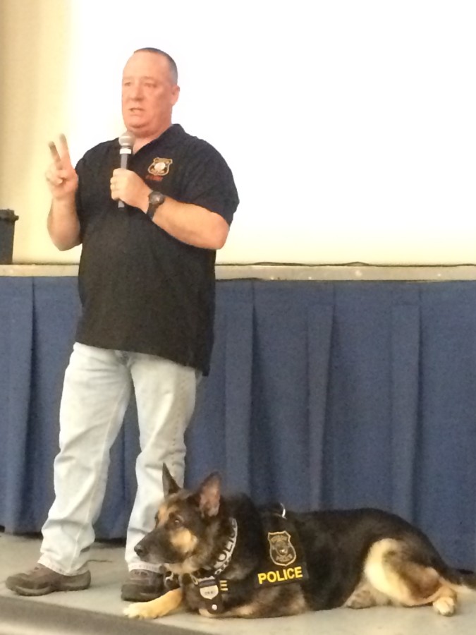 Officer Meade and Lucky talk to Colonia High School students.