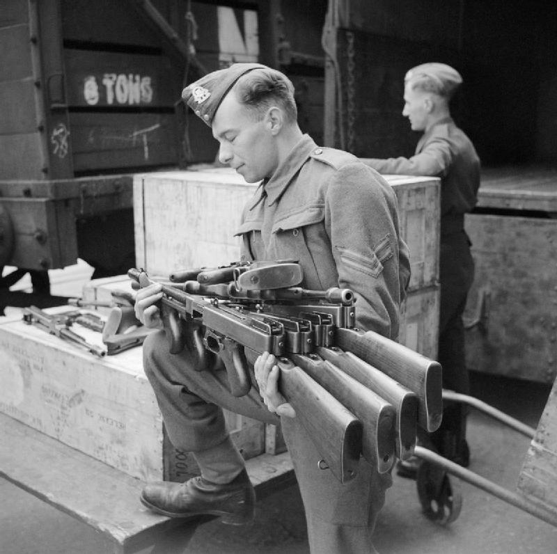Thompson_submachine_guns,_or_Tommy_guns,_being_un-crated_at_an_ordnance_depot_in_the_UK_after_their_arrival_from_the_US_through_the_Lend-Lease_scheme,_23_March_1942._H18068