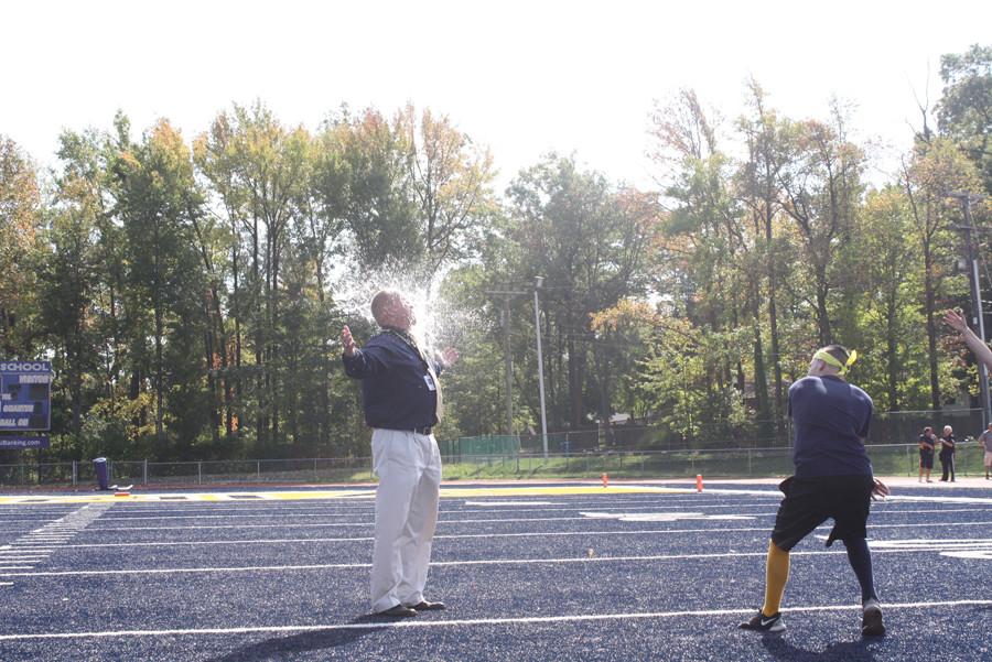 Principal Mr. Pace, being a good sport, embraces a water balloon breaking. 