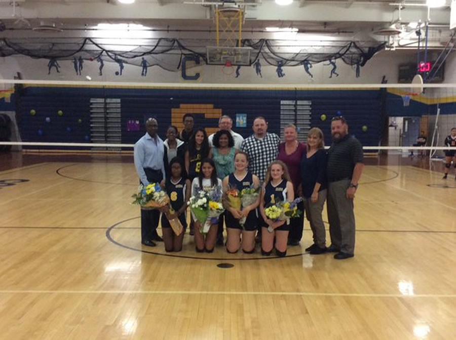 varsity senior girl volleyball players with their parents 