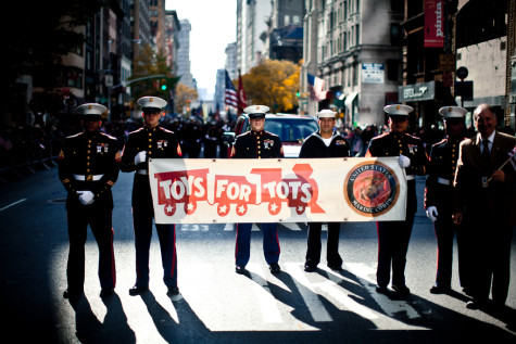 Marching through the streets, the marines advertise Toys for Tots.