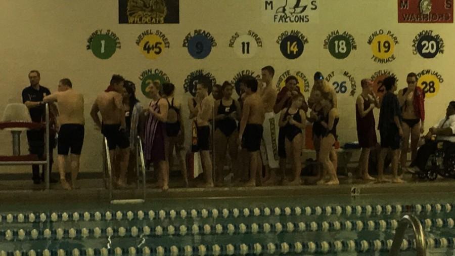 The Swimming Patriots huddle up; before their meet against the Red Barrons. 