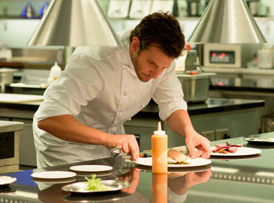 Bradley Cooper as Chef Adam Jones preparing a meal in the movie Burnt