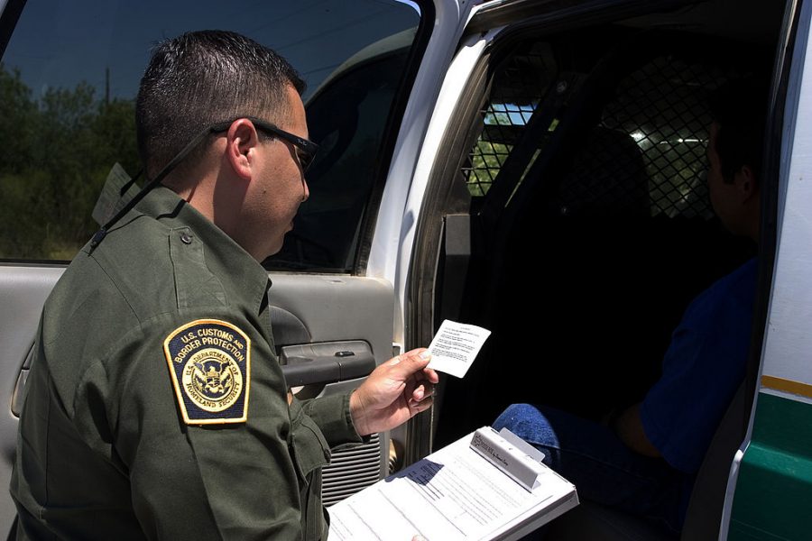 Border Patrol officer reads the Miranda Rights to a suspected criminal. 
