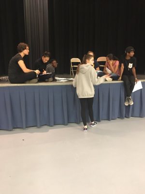The actors and directors of the fall showcase group together in rehearsal.