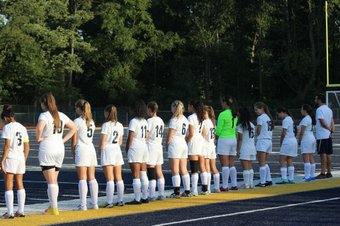 Waiting for the starting line up to be called, the CHS girls varsity soccer team get ready for a big game.