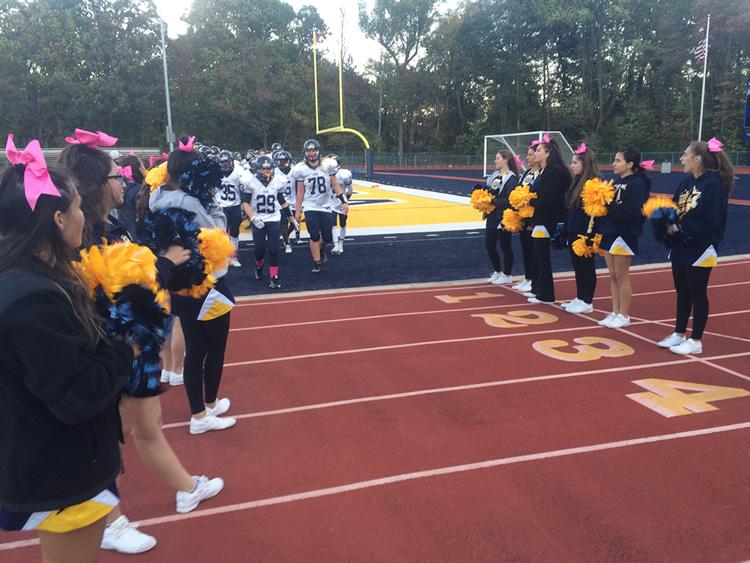 Starting their march the Colonia Patriots JV Football team stands strong after their victory.
