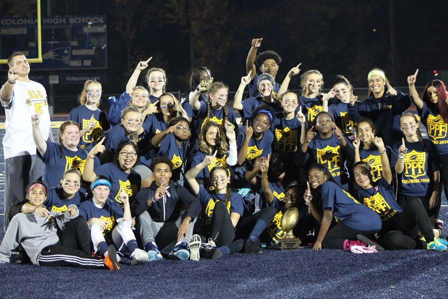 The Colonia girls powder puff team bring the trophy back home after making the most money against Woodbridge when the game ended as a tie. 