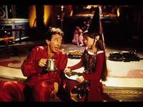 Tim Allen as Santa Clause talks to elf Judy over a steaming cup of hot coco.