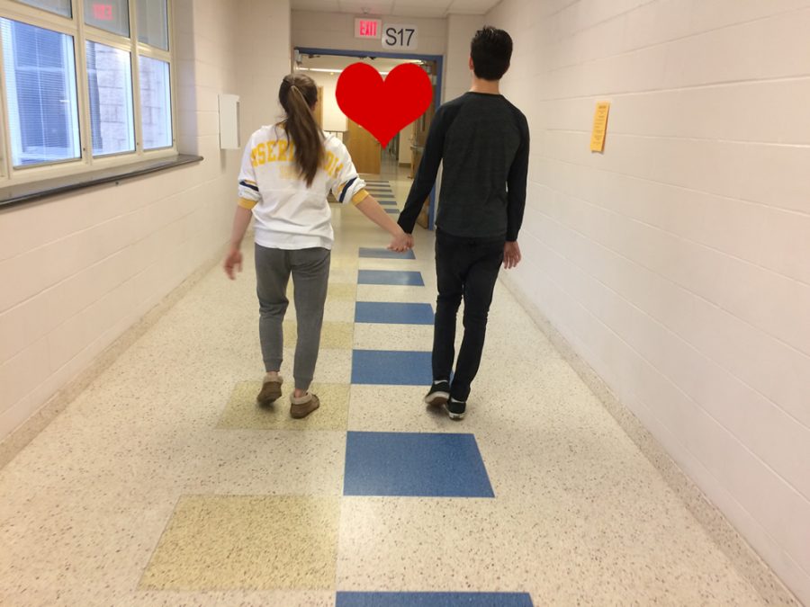 A high school couple walking hand in hand down the hallways of CHS. 