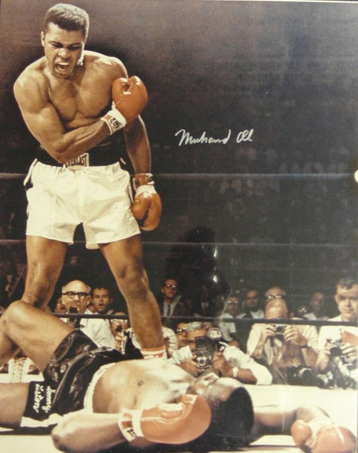 Muhammad Ali stands over his opponent in victory.