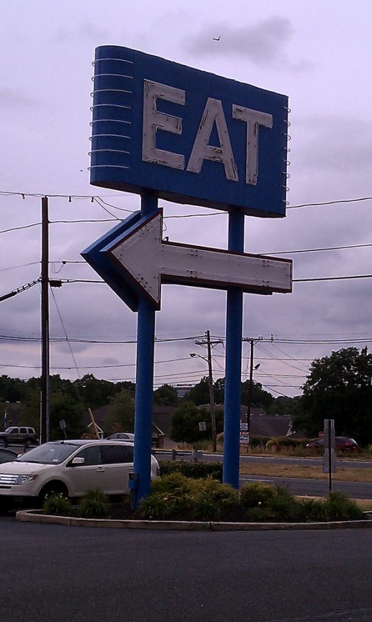 The big neon sign placed in front of the restaurant to help attract customers.