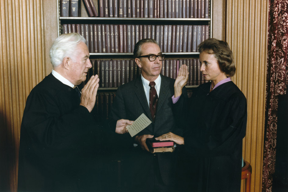 Raising her right hand, Sandra Day OConnor is sworn in as the first female supreme court justice in 1981.  