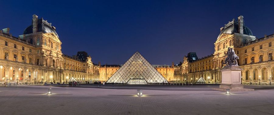 A modern image of the front of the Louvre depicts the famous glass pyramid that acts as an entrance to the most famous works of arts known to man kind. 
