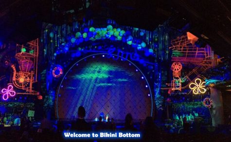 The colorful stage displayed under black lights for Spongebob The Musical.