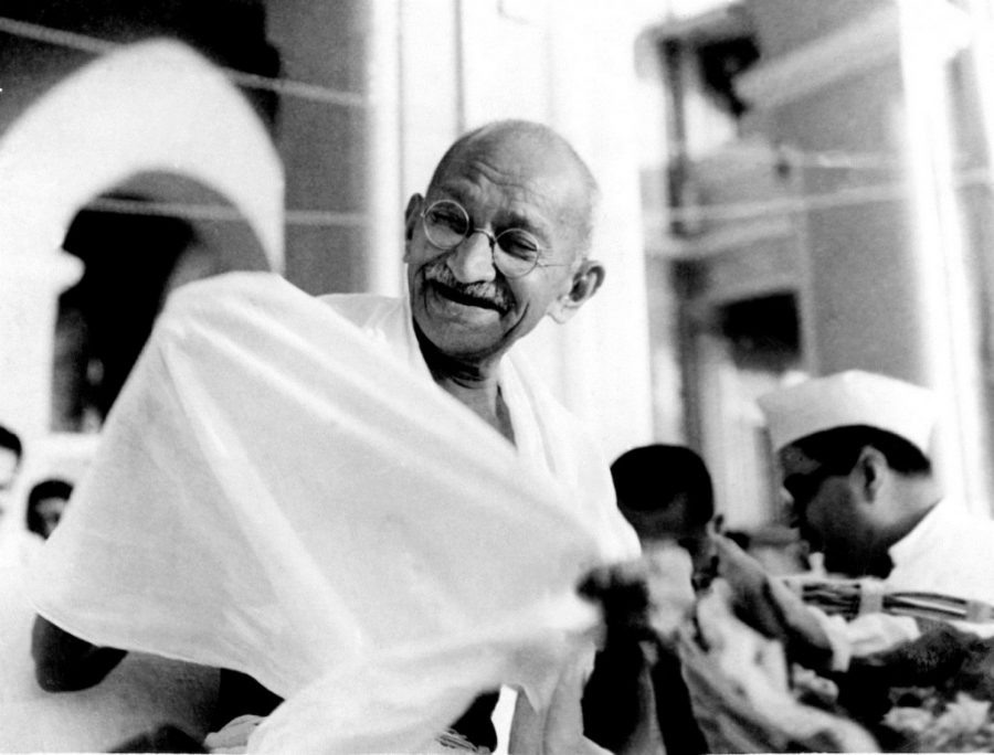 Surrounded by his supporters Gandhi smiles. 