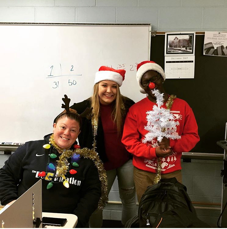 Decked out for the holidays, Journalism Teacher, Mrs. Danielle Allen, poses with editors Frankie Brock and DeAndre Oglesby for the class Christmas card.