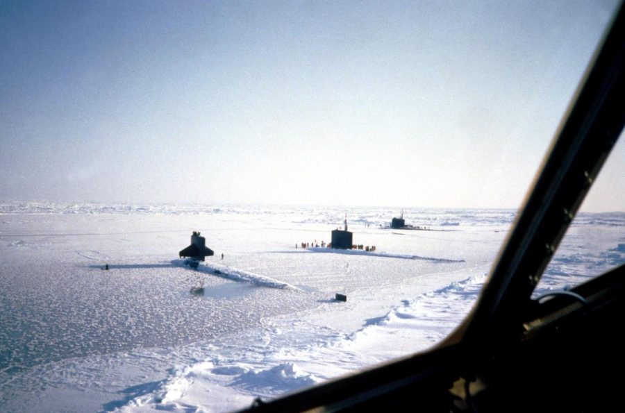 Breaking the ice, two Submarines come up out of the water at the Geographic North Pole.