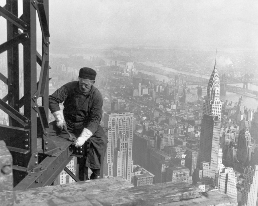 Hanging high, this worker helps to construct the Empire State Building in the 1930s.