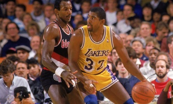 Seen here is the great Magic Johnson, using his unusually large frame for a point guard to post up what seems to be a bigger defender.