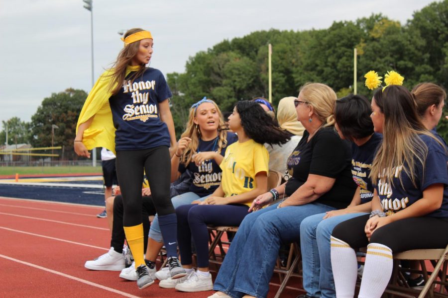 Senior Class Officer, Alexandra Poulakowski participating in musical chairs during the pep rally.