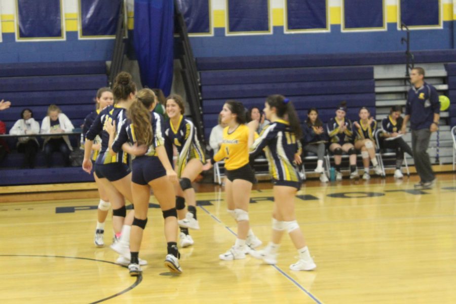 Colonia girls celebrating, due to scoring a point. 