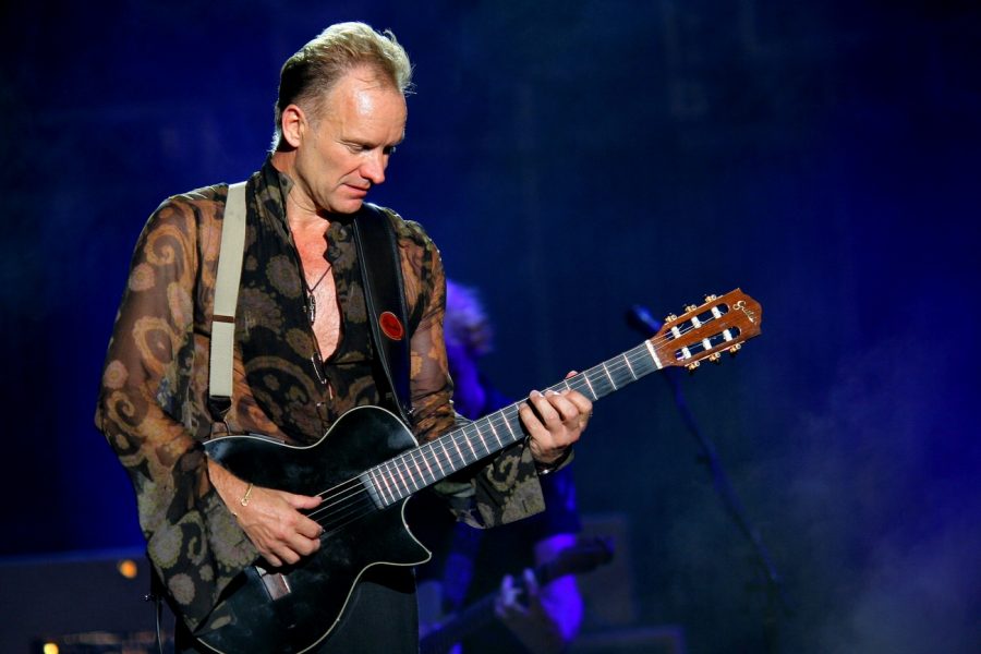 Playing a song from his album, Sting is focused on giving a good performance. 