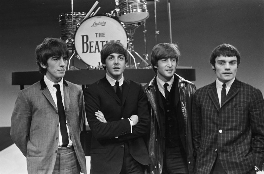 Answering+questions+about+their+songs%2C+The+Beatles+just+finished+performing+on+live+television.+