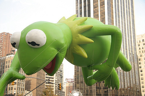 Flying high above Manhattan, Kermit the Frog from the Muppets Show is always a crowd pleaser at the Macys Thanksgiving Day Parade.