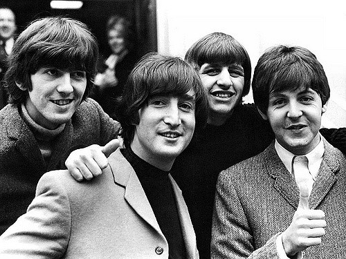 Smiling at their fans, The Beatles, are happy about their fourth album.