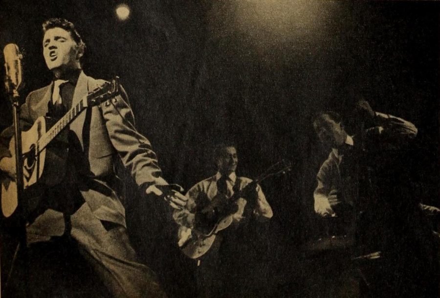 Singing from his album G.I. Blues, Elvis Presley, performs with a group. 