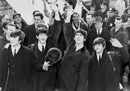 Smiling at their fans, The Beatles, are happy about their fourth album.