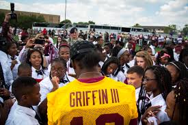Seen here is former Heisman Trophy winner Robert Griffin III signing autographs for the fans of his first NFL team, the Washington Redskins.