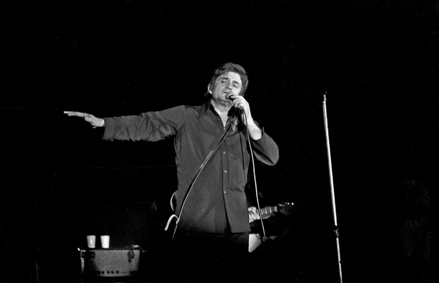 Performing Ring of Fire, Johnny Cash sings at the concert years after its debut.