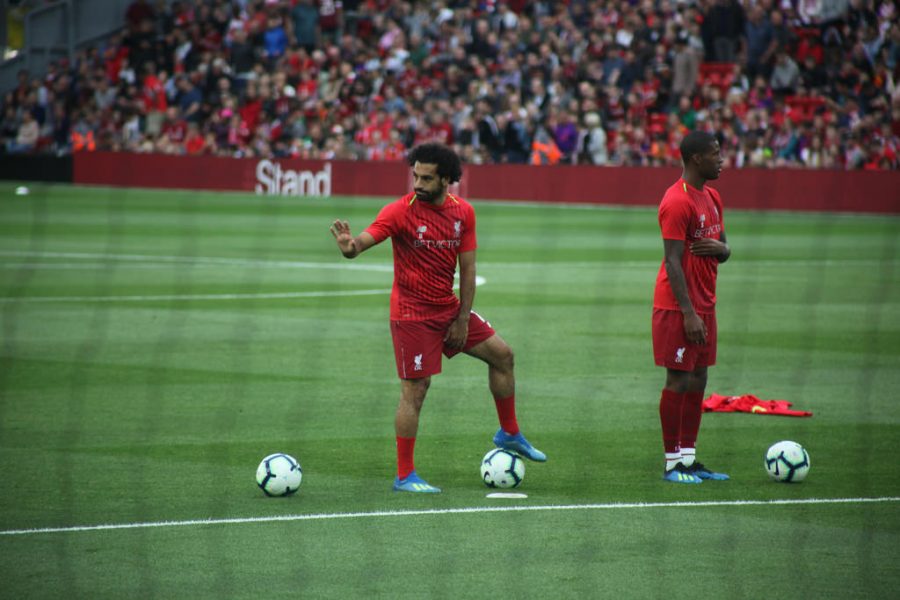 Seen here is star Liverpool soccer player Mo Salah (left) warming up before a game with a teammate.