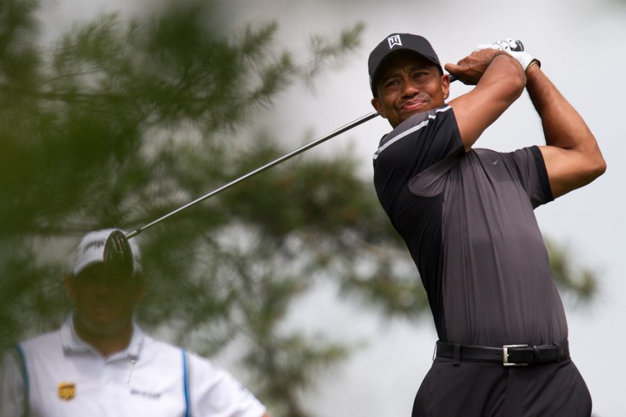 Seen here is legendary golfer Tiger Woods following through on his drive.