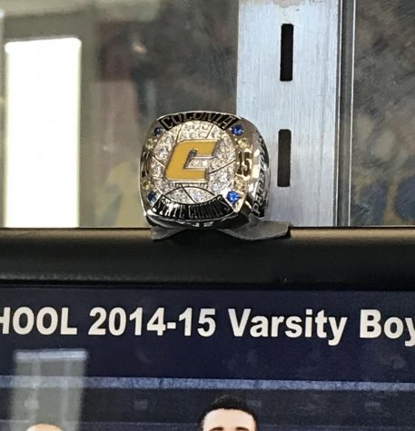 A photo of the 2014-2015 season ring. The ring sits in the trophy case in Colonia High Schools lobby.