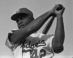 Seen here is Jackie Robinson of the Dodgers practicing his swing wearing the very famous number 42.