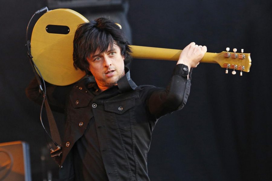 Playing his guitar in a unique fashion, lead singer Billie Joe Armstrong, is honored for his induction. 