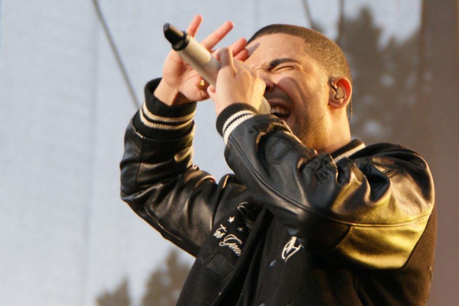 Rapping to one of his many hits, Drake is honored to have won 13 times. 