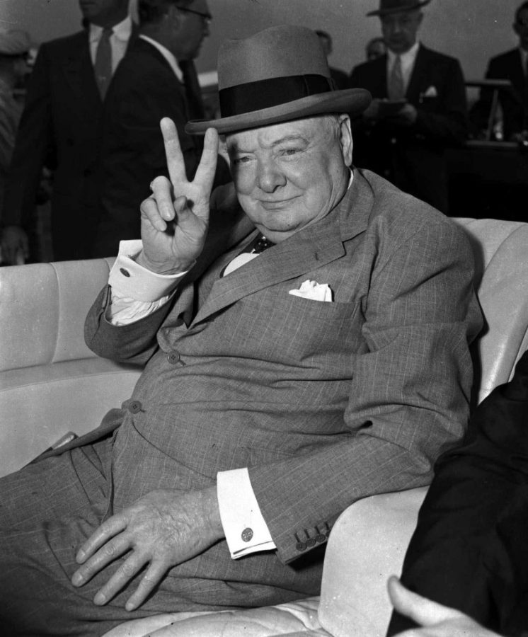 ADVANCE FOR SUNDAY, SEPT. 26--FILE--British Prime Minister Winston Churchill responds with the V for victory sign he made a trademark during World War II as spectators cheer his arrival at National Airport in Washington, D.C., June 25, 1954. Churchills defiant words and determination during World War II helped his country through long years of sacrifice. (AP Photo)