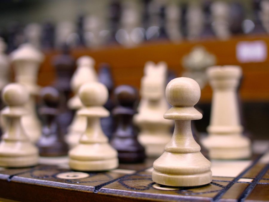 In a regular game of chess, two players work against each other to get the opponent’s king and win.