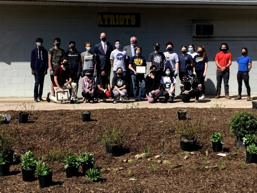 While finishing planting in the field  house rain garden, Mayor McCormac awarded Frankie Vasquez and Colonia High School with renewable energy awards.